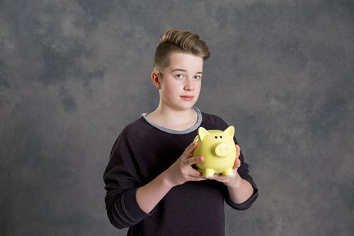 teenager showing piggybank